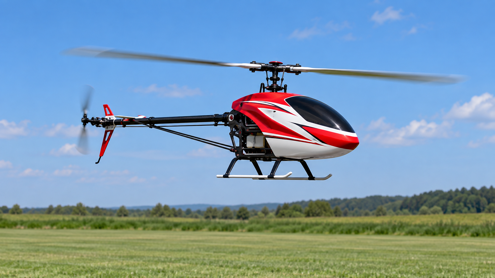 Red and white RC helicopter hovering over a flying field