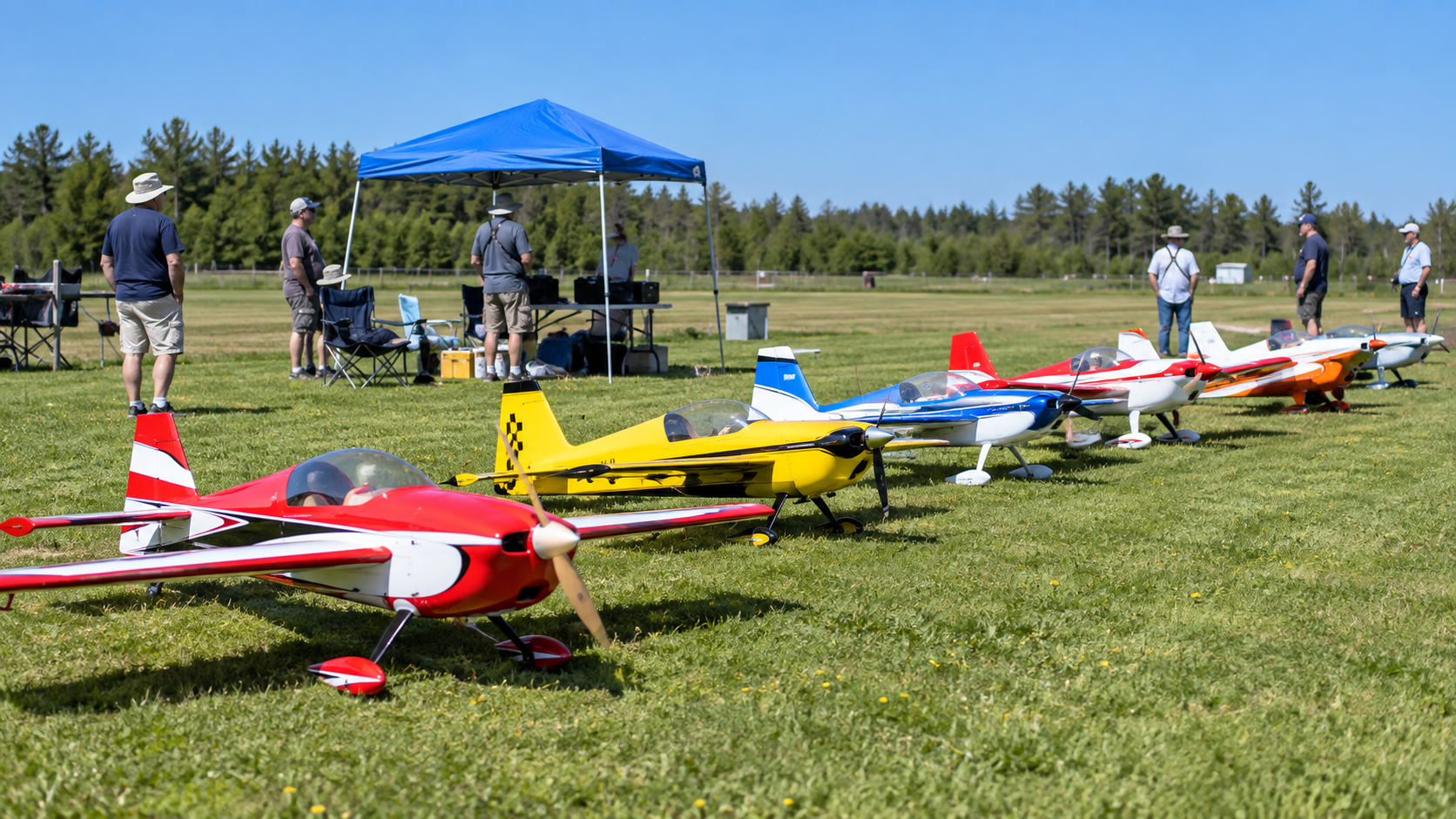 Colourful RC aircraft lined up at the club flying field